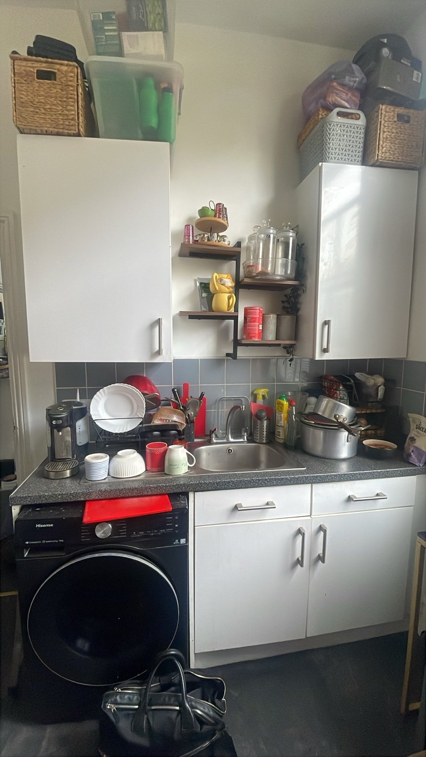 Home survey: the original sink, cabinets and tiled splashback.